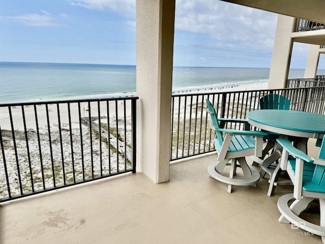 balcony featuring a beach view and a water view