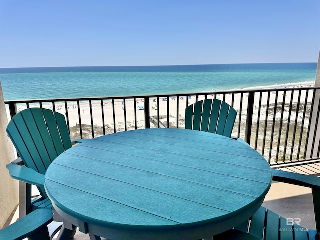 balcony with a water view and a beach view