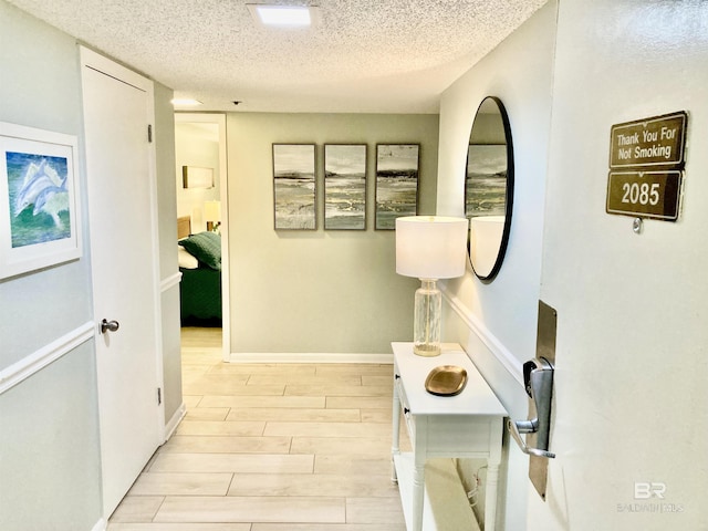 hallway featuring a textured ceiling