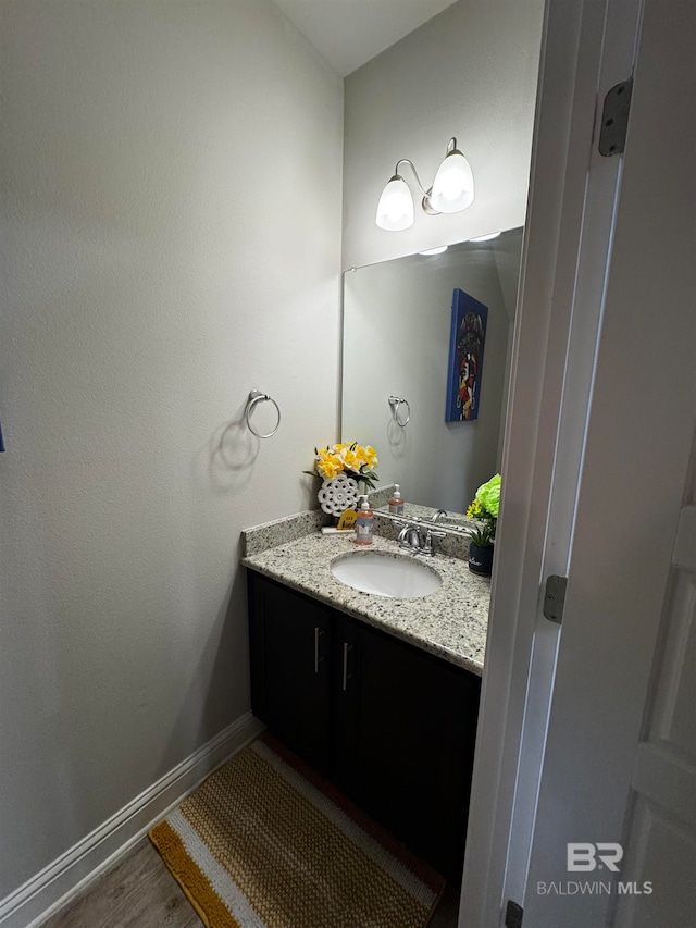 bathroom with hardwood / wood-style floors and vanity