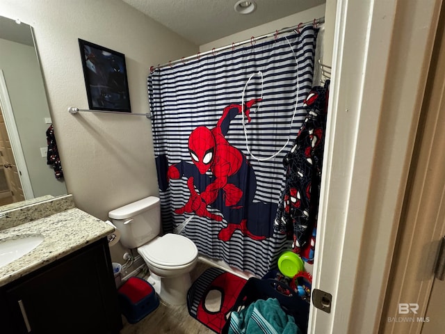 bathroom featuring hardwood / wood-style floors, vanity, a textured ceiling, and toilet