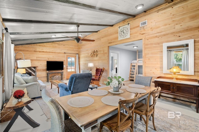 dining area with ceiling fan, wooden walls, and lofted ceiling with beams