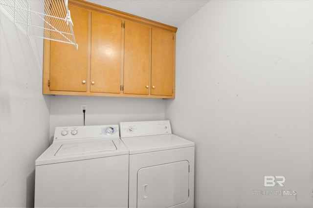 laundry room with separate washer and dryer and cabinet space