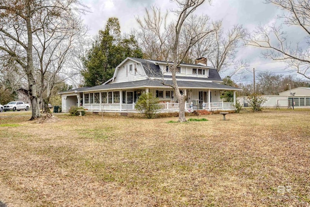 country-style home with a front yard and covered porch