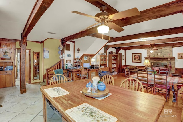 dining area featuring ceiling fan, light tile patterned floors, and beam ceiling