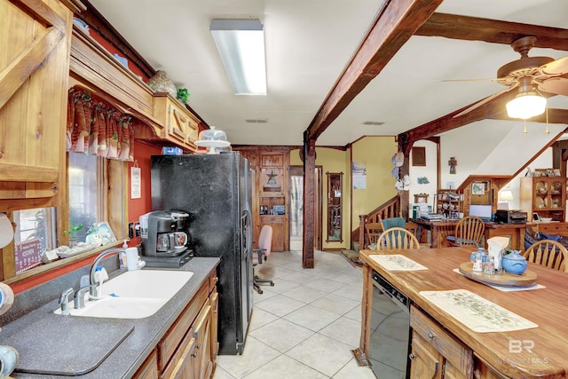 kitchen with light tile patterned flooring, beamed ceiling, sink, ceiling fan, and black appliances