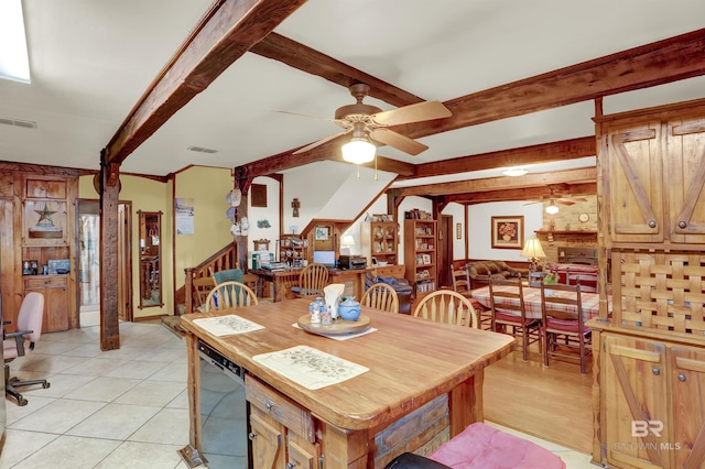 tiled dining space with beam ceiling and ceiling fan