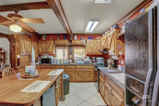 kitchen featuring light tile patterned floors, sink, ceiling fan, black appliances, and beamed ceiling