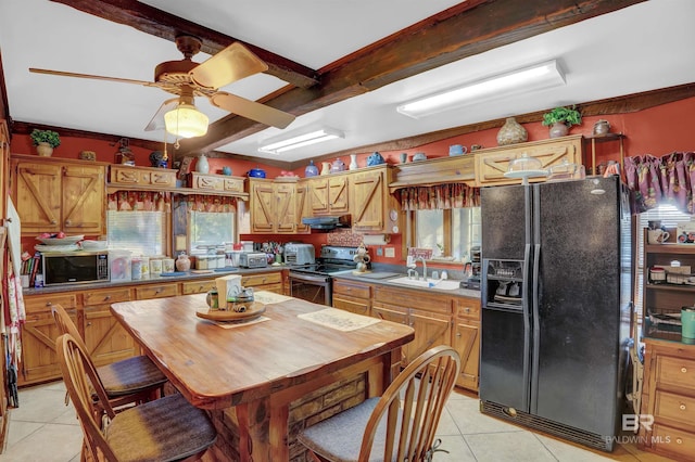 kitchen with sink, plenty of natural light, black appliances, light tile patterned flooring, and beamed ceiling