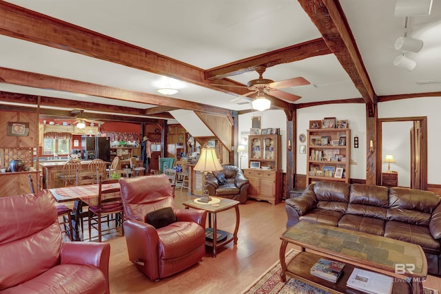 living room featuring beamed ceiling, light wood-type flooring, and ceiling fan