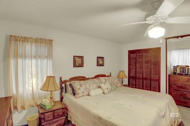 bedroom featuring ceiling fan and a closet