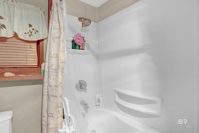 bathroom with toilet and shower / bath combo with shower curtain