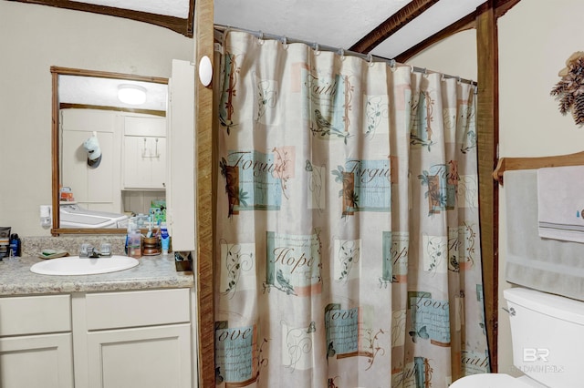 bathroom featuring vanity, toilet, and walk in shower