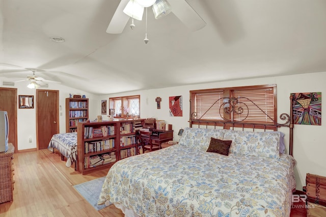 bedroom with ceiling fan, vaulted ceiling, and light hardwood / wood-style flooring