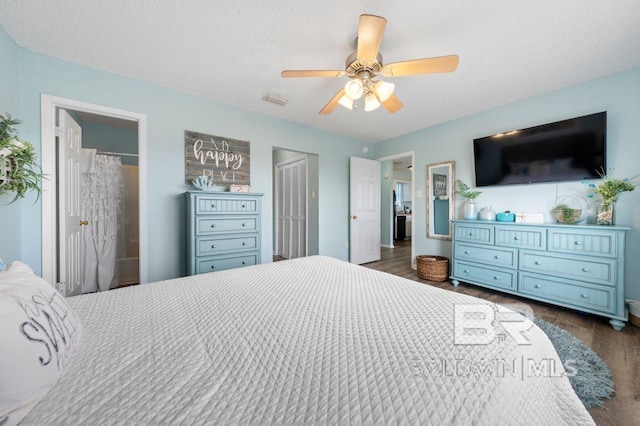 bedroom featuring visible vents, a textured ceiling, dark wood finished floors, and a ceiling fan