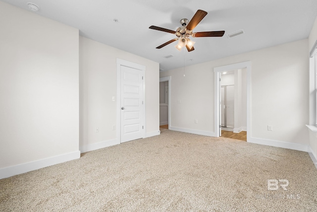 unfurnished bedroom with ceiling fan, connected bathroom, and light carpet