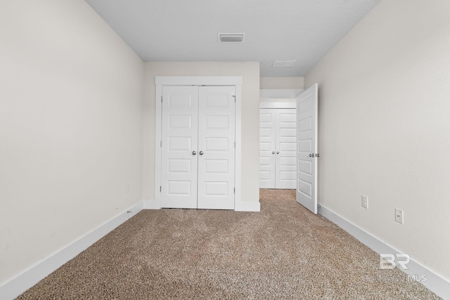 unfurnished bedroom featuring carpet floors and a closet