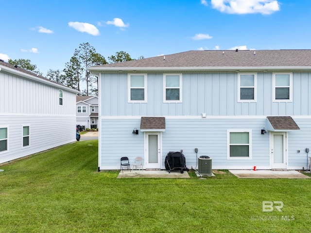 rear view of house with a yard, a patio, and central air condition unit