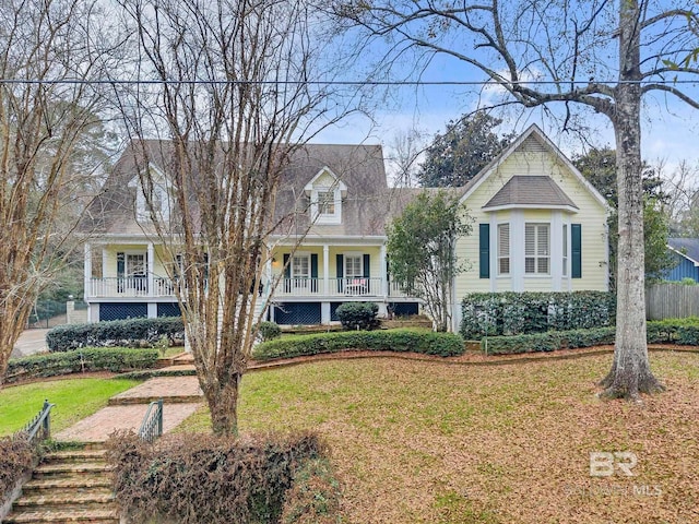 view of front of house featuring covered porch and a front yard