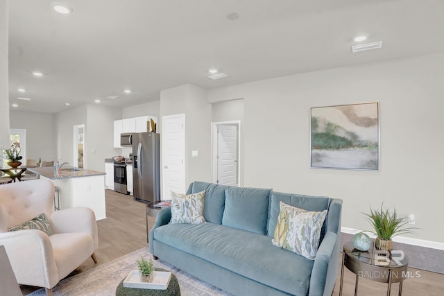 24926 Ponder Loop, Loxley, AL 36551 - living room with light wood-style flooring and recessed lighting