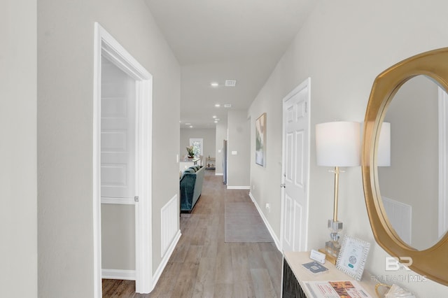 24926 Ponder Loop, Loxley, AL 36551 - hall with light wood finished floors, arched walkways, recessed lighting, and baseboards