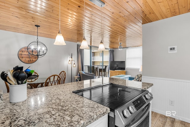 kitchen featuring hardwood / wood-style floors, wooden ceiling, stainless steel stove, light stone countertops, and decorative light fixtures