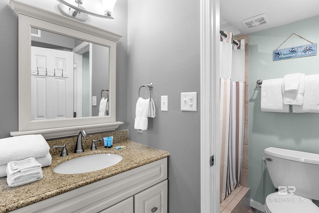 bathroom featuring curtained shower, vanity, and toilet