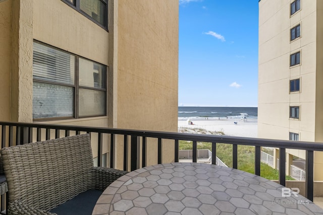 511 E Beach Blvd Unit 203, Gulf Shores, AL 36542 - balcony featuring a beach view, outdoor dining space, and a water view
