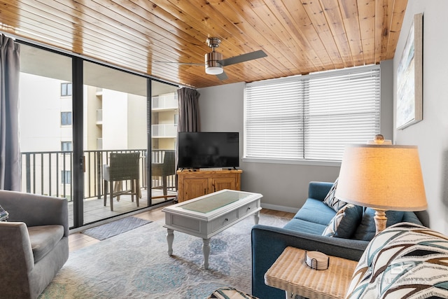 living room with light hardwood / wood-style flooring, ceiling fan, and wood ceiling