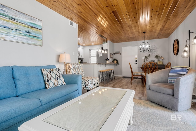 living room featuring wooden ceiling, light wood-type flooring, and an inviting chandelier