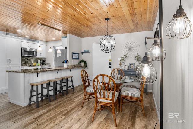 511 E Beach Blvd Unit 203, Gulf Shores, AL 36542 - dining area with light wood-type flooring, recessed lighting, a notable chandelier, and wood ceiling