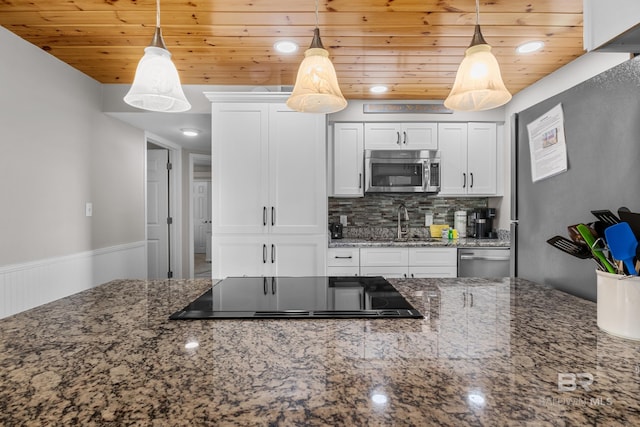 511 E Beach Blvd Unit 203, Gulf Shores, AL 36542 - kitchen featuring wood ceiling, decorative backsplash, white cabinetry, and stainless steel appliances
