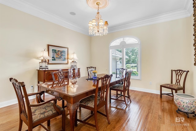 613 Wedgewood Dr, Gulf Shores, AL 36542 - dining room featuring a chandelier, light wood-style flooring, ornamental molding, and baseboards