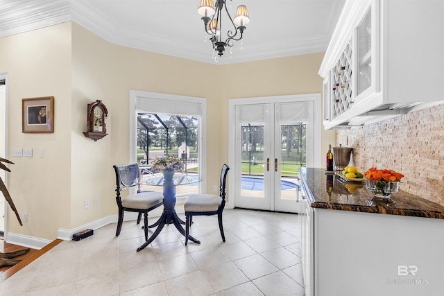 613 Wedgewood Dr, Gulf Shores, AL 36542 - dining area with ornamental molding, french doors, a chandelier, light tile patterned floors, and baseboards