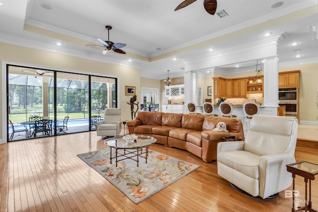 613 Wedgewood Dr, Gulf Shores, AL 36542 - living room with ceiling fan, light wood finished floors, ornamental molding, and ornate columns