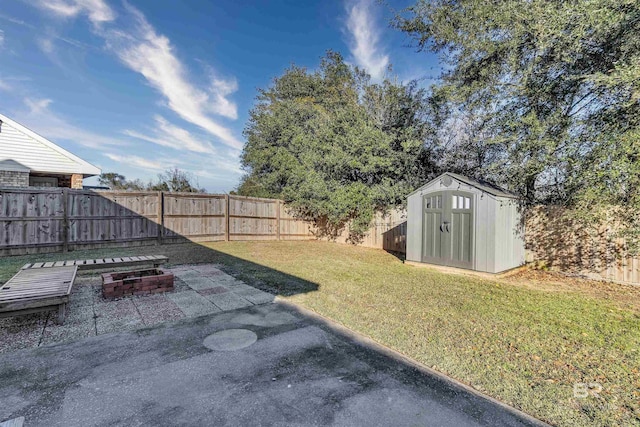 view of yard with a patio area and a storage shed