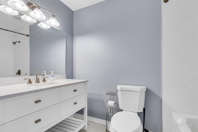 bathroom featuring tile patterned flooring, vanity, and toilet