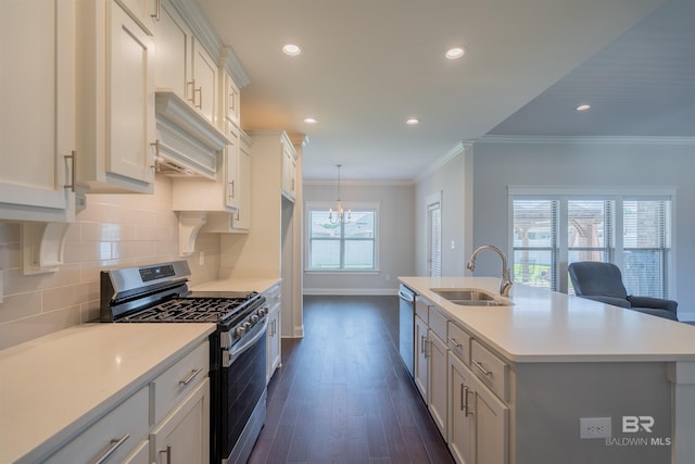 kitchen featuring a kitchen island with sink, sink, ornamental molding, dark hardwood / wood-style flooring, and stainless steel appliances