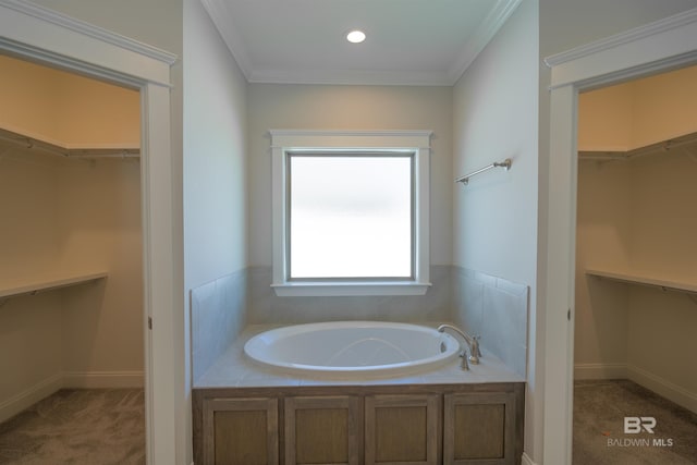 bathroom featuring a washtub and crown molding