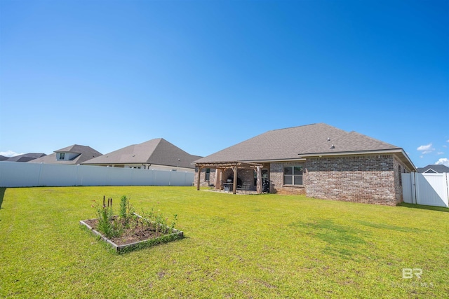 rear view of house with a yard