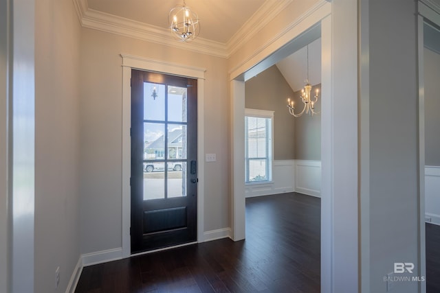 entryway with lofted ceiling, crown molding, dark hardwood / wood-style floors, and an inviting chandelier