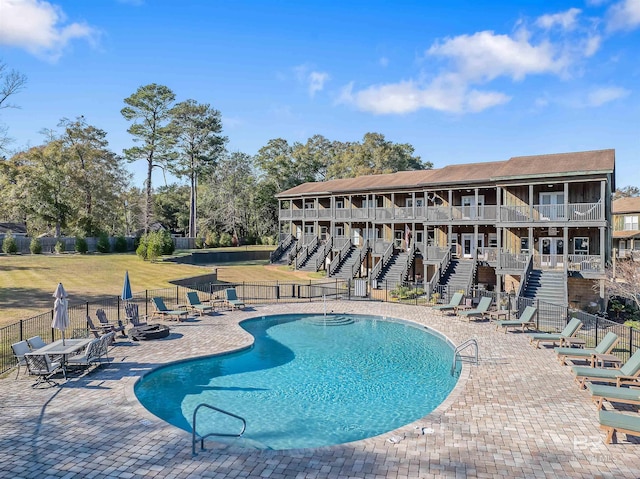 view of pool featuring a lawn and a patio area