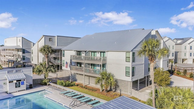 exterior space featuring a residential view and fence