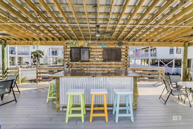 deck featuring ceiling fan and outdoor dry bar