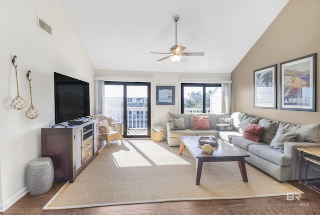 living area with visible vents, baseboards, ceiling fan, wood finished floors, and high vaulted ceiling