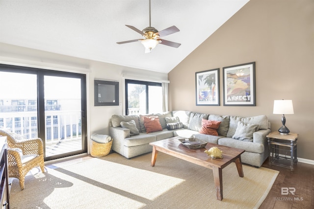 living area with high vaulted ceiling, wood finished floors, a ceiling fan, and baseboards