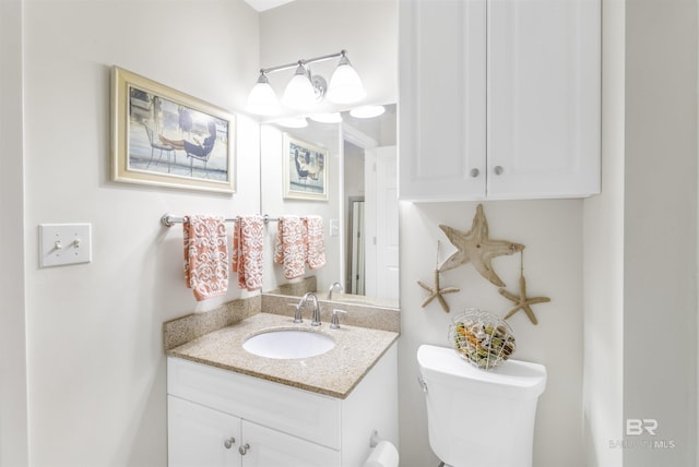 half bathroom featuring toilet and vanity