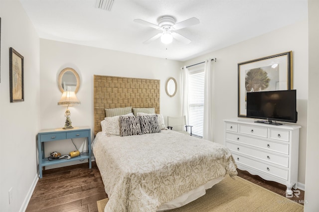 bedroom featuring dark wood-style flooring, visible vents, ceiling fan, and baseboards