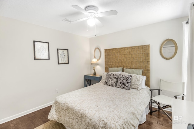 bedroom featuring ceiling fan, baseboards, visible vents, and dark wood finished floors