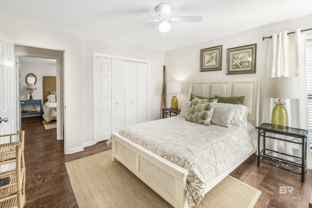 bedroom featuring a closet, dark wood finished floors, a ceiling fan, and baseboards